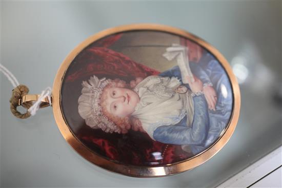 Early 19th century English School Miniature portrait of a lady, seated holding a letter, 2.75 x 2.25in. gold frame with enamelled back.